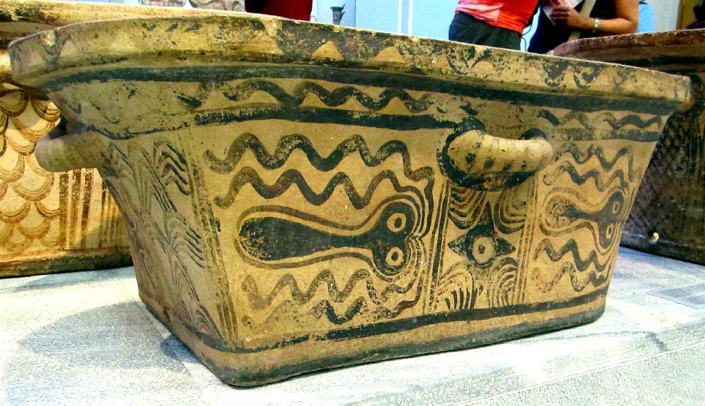 Ein Larnax, also ein Betattungsgefäß aus dr minoischen Bronzezeit mit einer Stilisierten Ocotpusbemalung. Zwei Oktopusse sid zu sehen, die mit jeweils ur 4 Armen gezeigt werden.