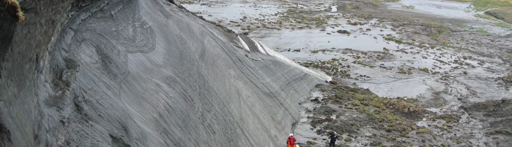 Messungen an einer Klippe, welche durch den Permafrost abtaut und ins Meer stürzt. Oben und unten an der Klippe stehen Menschen, die sie vermessen, im Vergleich zur Klippe wirken sie kleiner als Lego.