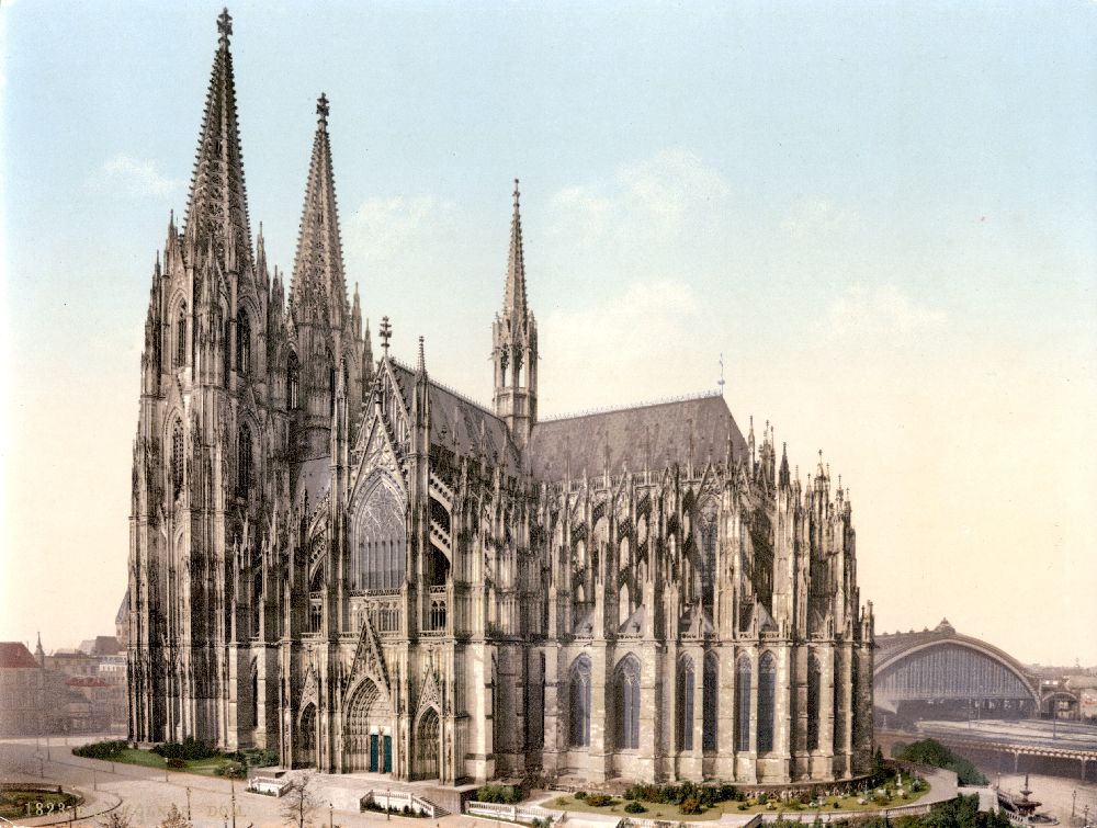 Malerei im Vordergrund der Kölner Dom direkt dahinter schaut der Hauptbahnhof hervor.